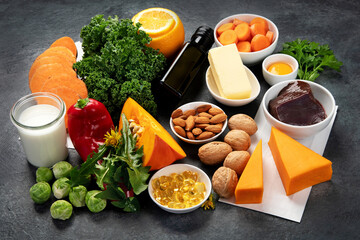 Foods high in vitamin A on dark background.