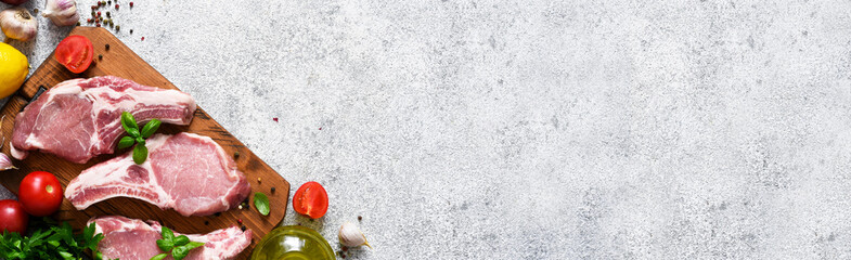 Pork steak and spices, vegetables, oil on a light background. Fresh meat. Advertising. Food delivery.
