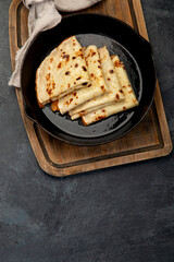 Crepes with sweet toppings on dark background.