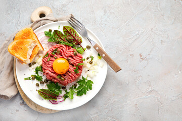Beef steak tartare on light background. French cuisine concept.
