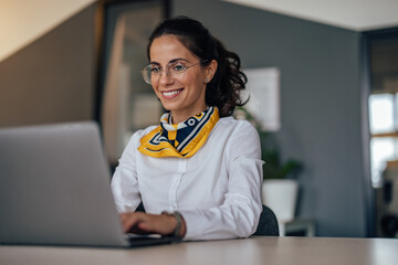 Adult woman, using her new laptop for work.