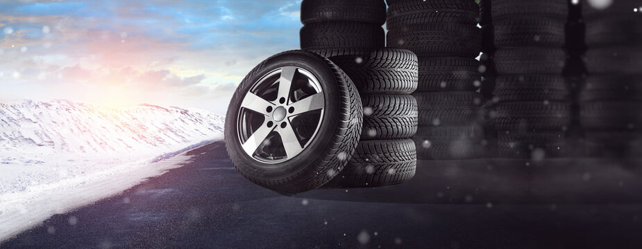 Winter tires in the snow in winter as a panorama - stored at the dealer