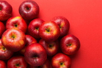 Many red apples on colored background, top view. Autumn pattern with fresh apple above view with copy space for design or text