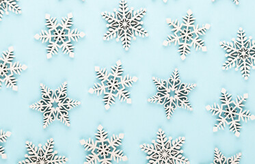 Christmas background. White snow decorations on a pink background.