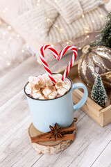 Christmas candy cane heart shape, bokeh background.