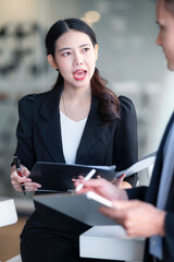 Young business people discussing about business plan while standing in office.