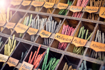 Colorful incense sticks  in outdoor street shop with names in spanish
