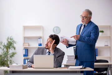 Two male colleagues working in the office