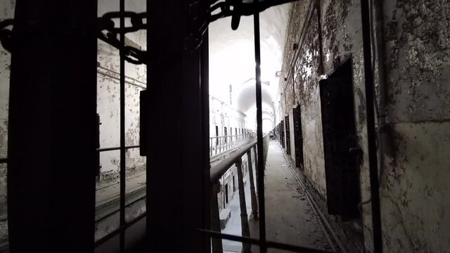 Camera view of cellblock pedestals up and down through gate at Eastern State Penitentiary.