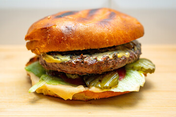 Tasty cheeseburger on the wooden board