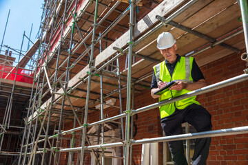 Male Builder Construction Worker Contractor on Building Site With Clipboard
