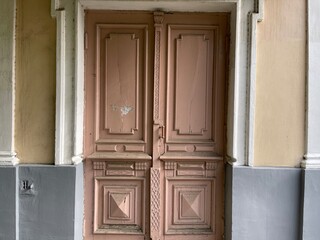 Exterior of architectural doors. Shabby closed double door.