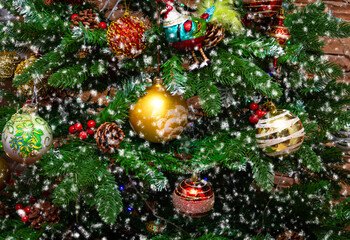 Fototapeta na wymiar Christmas tree decorated with Christmas decorations and falling snow. Christmas and New Year.