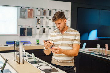 Man selecting smartphone from stall