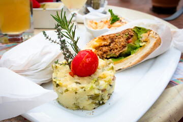 Delicious pulled pork sandwich with potato puree and coleslaw salad