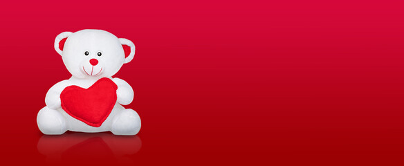 Valentines Day Teddy Bear on wide red gradient background. Copyspace.