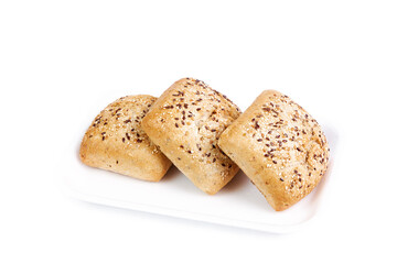 Three square seeded muffins isolated on white tray and background