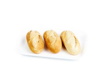 Three white buns isolated on a white tray and background