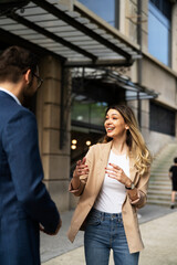 Fototapeta premium Young businesswoman and businessman standing on the street Beautiful businesswoman talking with her colleague.