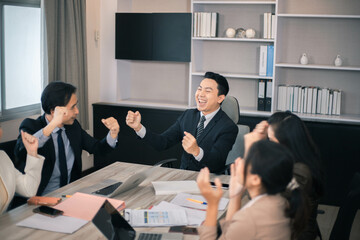 Business people meeting and discussing documents and ideas at meeting around table.