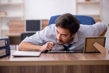 Young male drug addicted employee at workplace