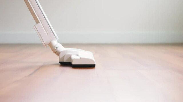 White vacuum cleaner on laminated floor.