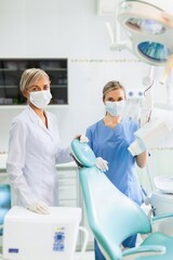 Portrait of a Female Dentist with Assistant