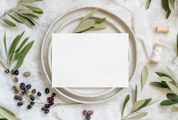 Fototapeta na wymiar Wedding Table place with a card decorated with olive branches
