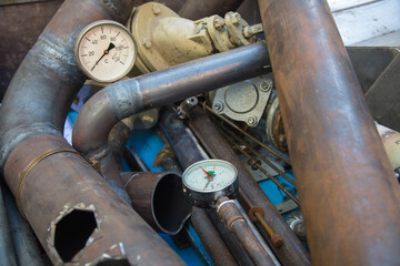 Special waste or valuable resources: Old rusty components of a heating boiler as pipes, counters,...