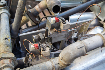 Special waste or valuable resources: Old rusty components of a heating boiler as pipes, counters, electric parts or control elements ready for removal or metal, cast iron and aluminium recycling