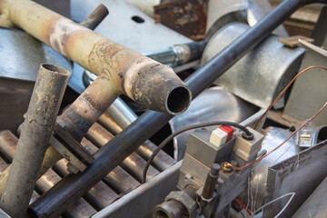 Special waste or valuable resources: Old rusty components of a heating boiler as pipes, counters,...