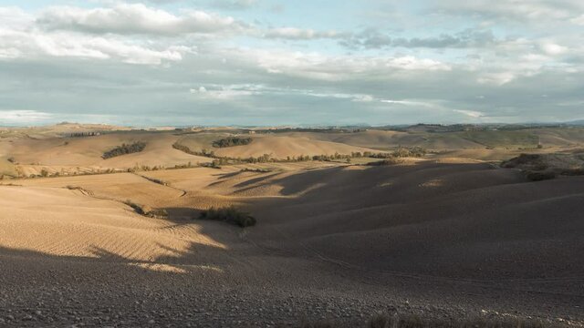 rolling hills of tuscany in the evening sunlight