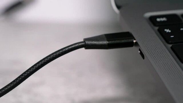 Close up circle movement of USB type-c cable connector in black color to connect with laptop or charge gadget.