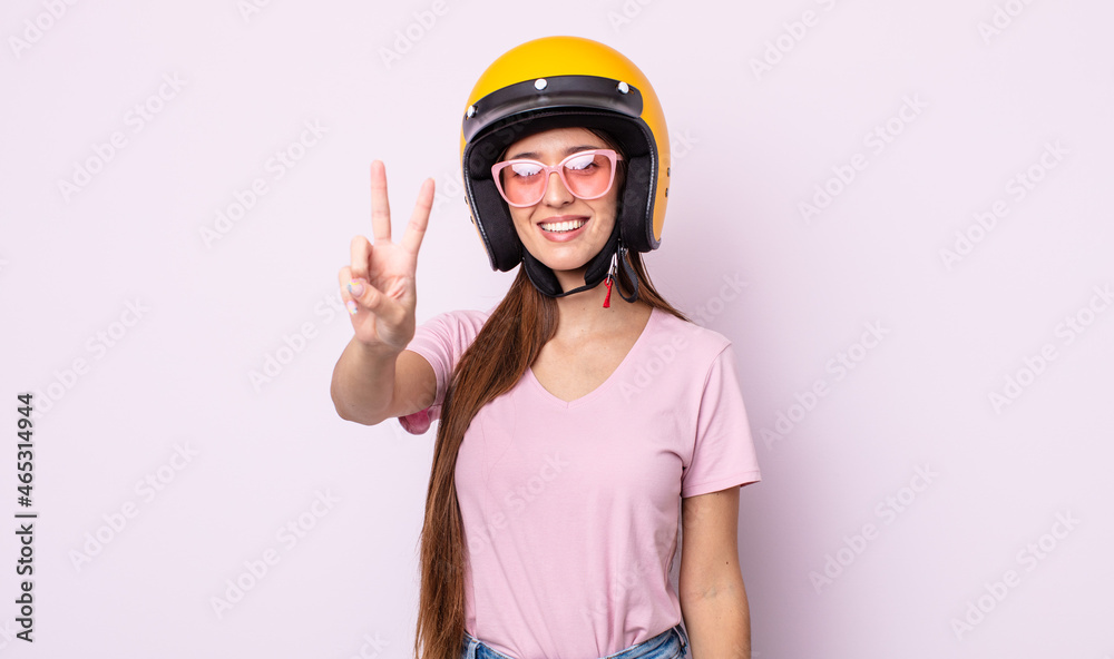 Poster young pretty woman with a motorbike helmet.