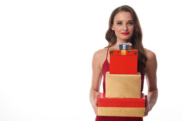 Portrait of content attractive young Caucasian woman holding stack of Christmas presents against white background
