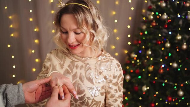 a man makes a marriage proposal at the Christmas tree. engagement. happy lovers. 