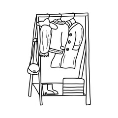 Modern wooden floor rack for clothes, rail. The bag hangs on the side. Coat, scarf and warm sweater. There are shoes and a box on the shelf. Black and white vector isolated illustration doodle