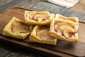 Puff pastry filled with apples on a wooden table