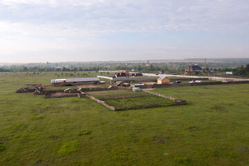 Top-view of an earth with fields and a typical farm from a basket of a hot-air balloon