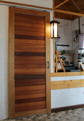 A wooden sliding door in a cafe.