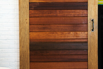A wooden sliding door in a cafe.