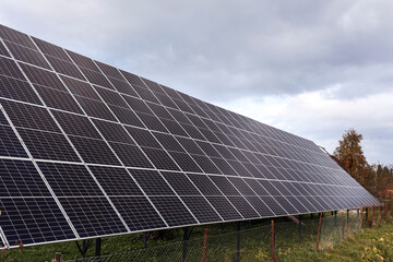 Solar panels on a metal structure on the ground. Solar farm on sky background