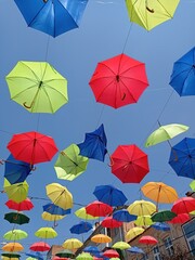 Fototapeta na wymiar Background colorful street decoration, with one distructed umbrella