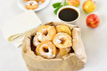 Donuts with powdered sugar in paper bag