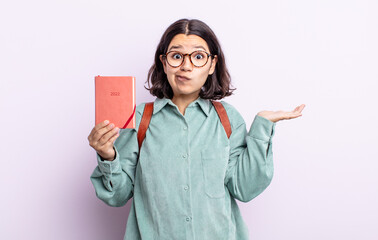 pretty young woman feeling puzzled and confused and doubting. 2022 agenda concept