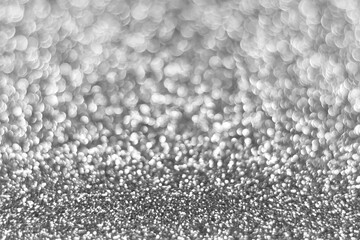 Silver sparkling glitter bokeh background, christmas abstract defocused texture. Holiday lights