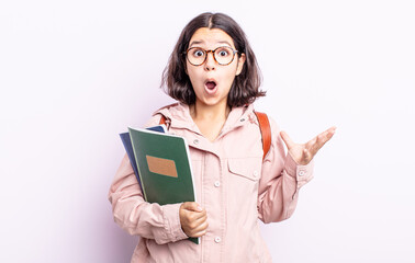 pretty young woman amazed, shocked and astonished with an unbelievable surprise. student with books...