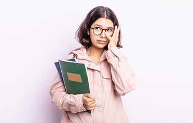 pretty young woman feeling bored, frustrated and sleepy after a tiresome. student with books concept