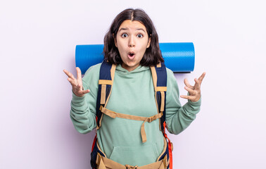 pretty young woman amazed, shocked and astonished with an unbelievable surprise. hiking concept