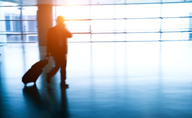 Fototapeta na wymiar Walking passenger at the airport, motion blur..